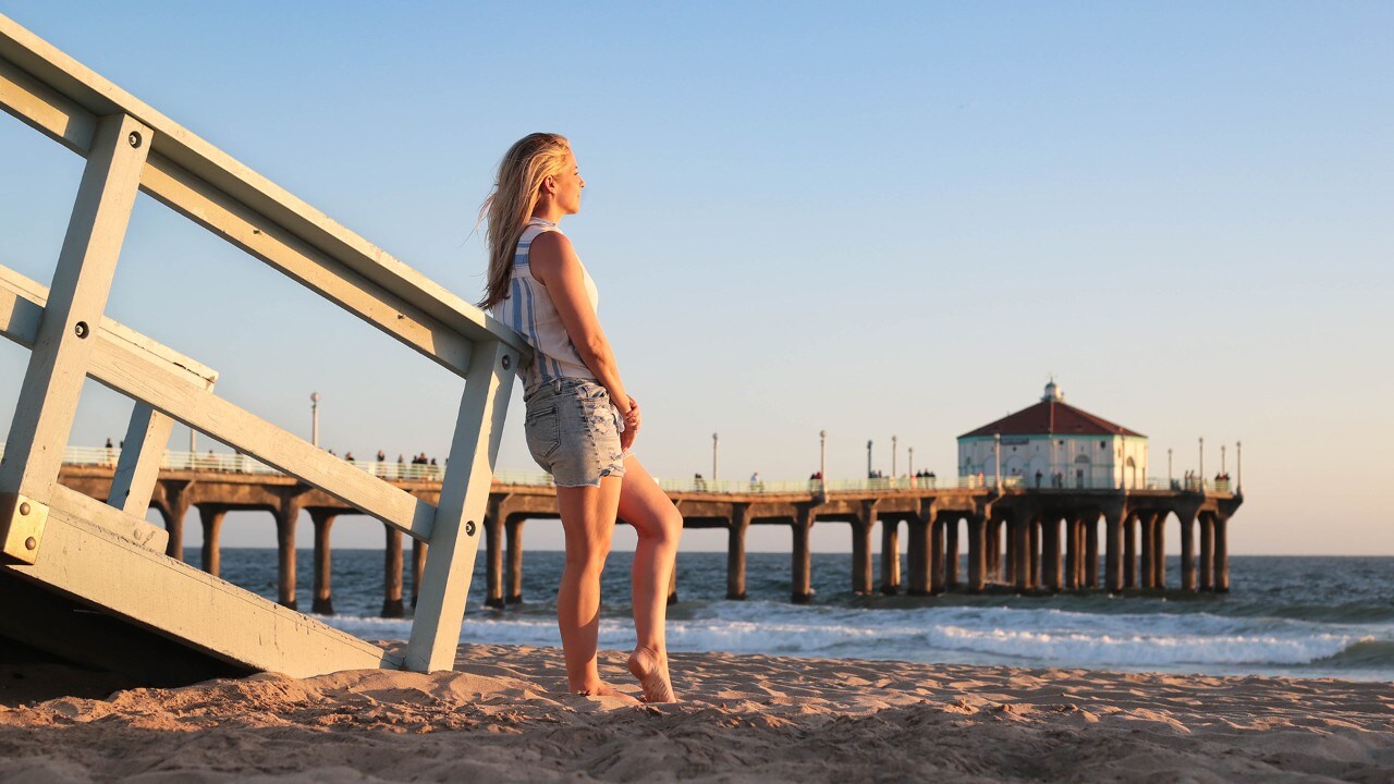 The author, a Southern California native, watches the sunset on Manhattan Beach. "It never gets old," she said. 