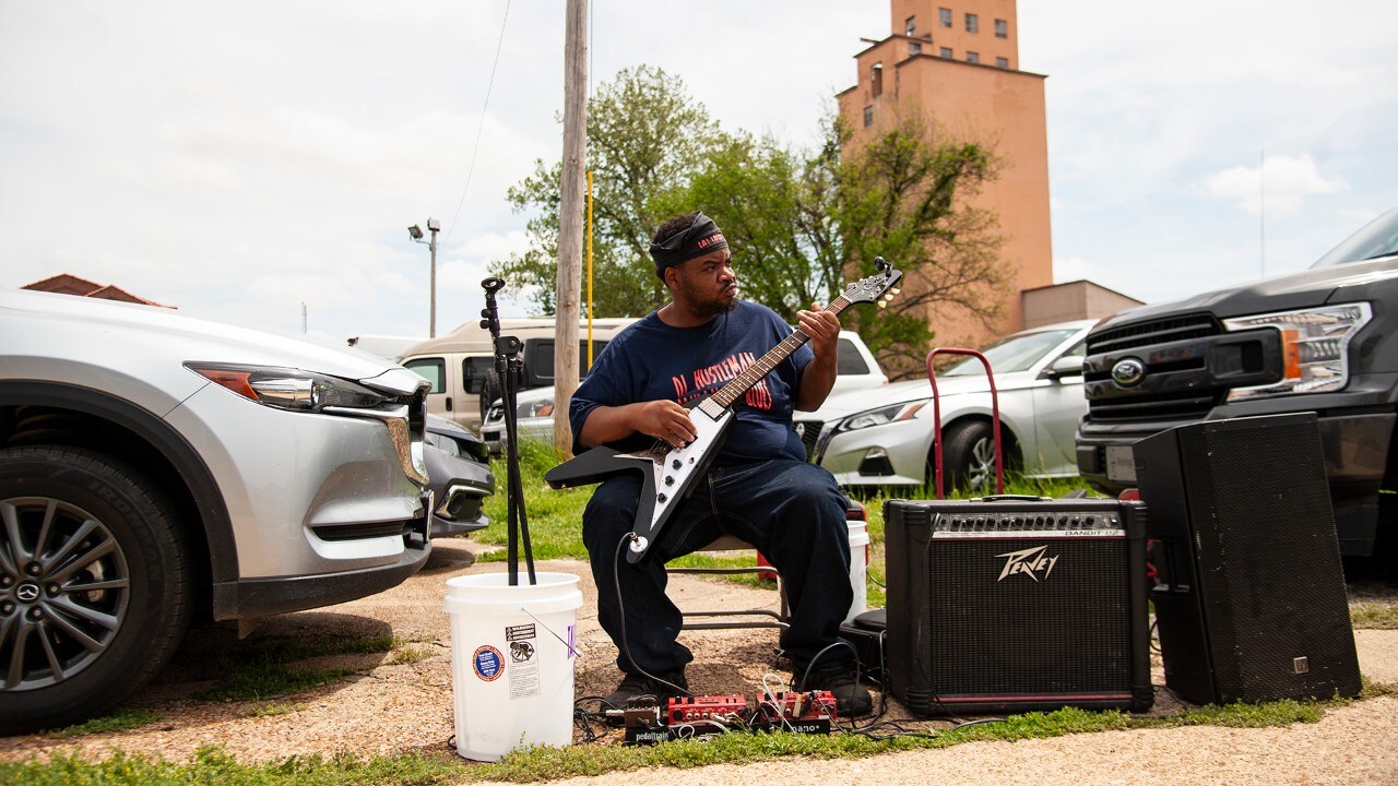 Obbie Riley, aka DJ Hustleman, plays for passersby in Clarksdale.