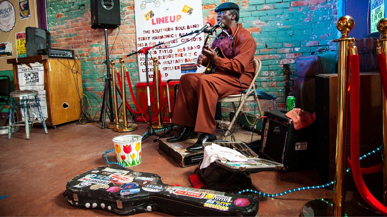 Terry “Harmonica” Bean plays inside the Delta Blues Alley Cafe during Clarksdale, Mississippi’s annual Juke Joint Festival. 