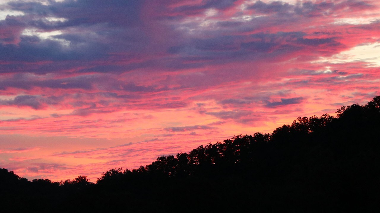 A fiery sunset lights up the evening sky. 