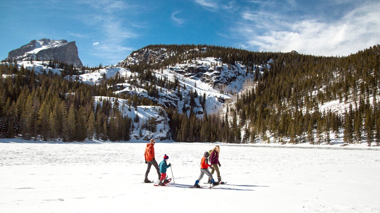 A family showshoes in Rocky Mountain National Park. Photo by Brad Clement