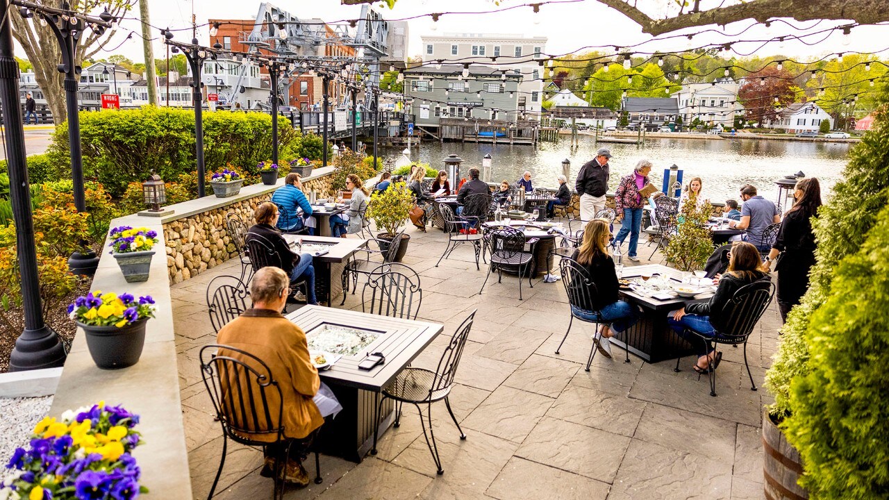 People dine along the Mystic River at S&P Oyster Restaurant and Bar.