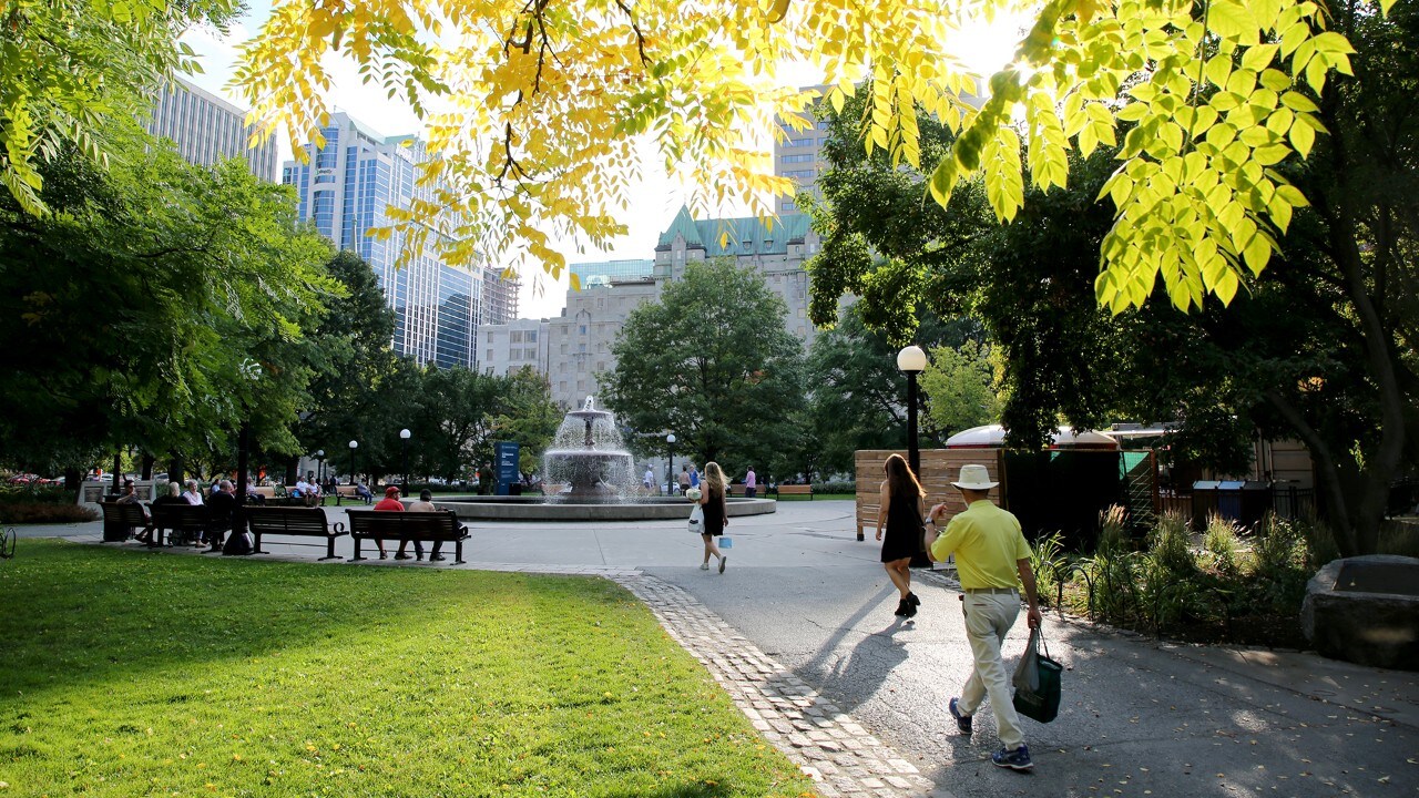 People stroll through Confederation Park.