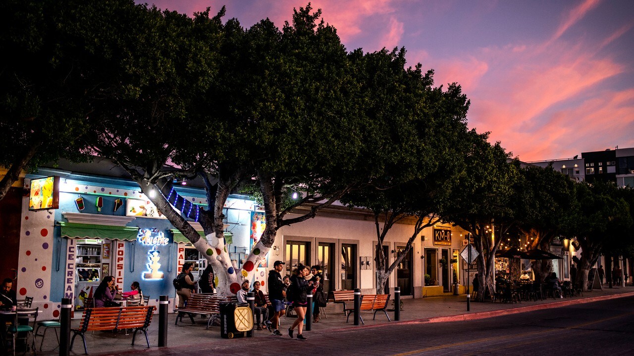 The sun sets over La Fuente ice cream shop, located on the Malecón in La Paz.