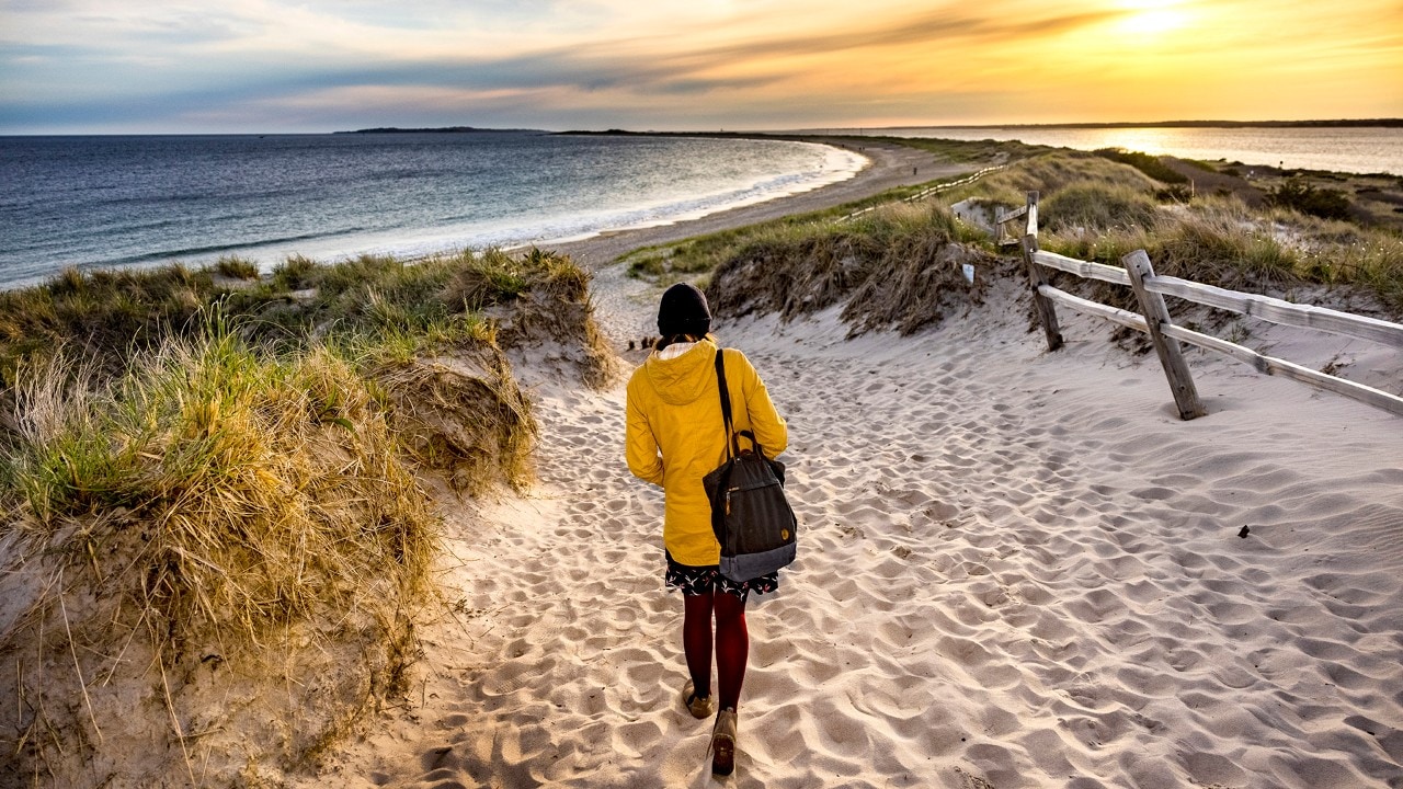 Author Kassondra Cloos walks down to the beach at Napatree Point Conservation Area in Westerly, Rhode Island.