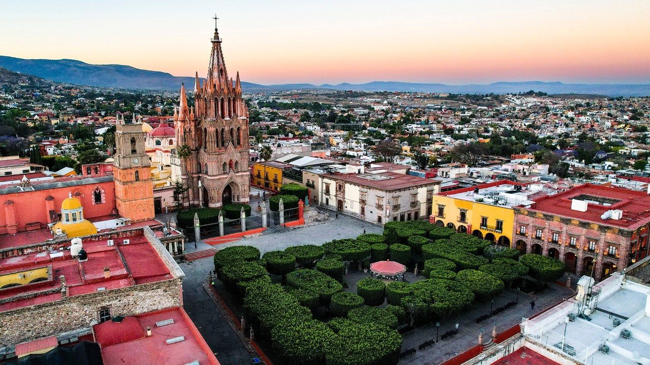 La Parroquia de San Miguel Arcángel lights up as the sun rises.