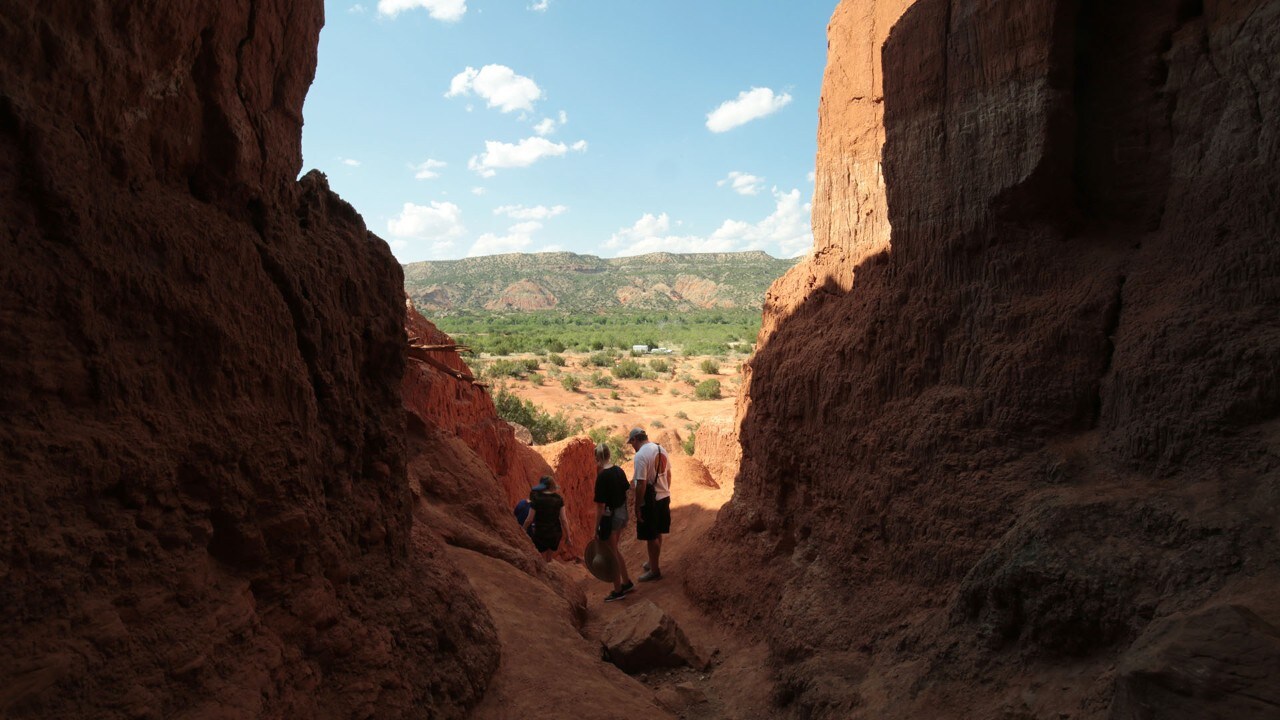 Visitors explore "The Big Cave" in Palo Duro.