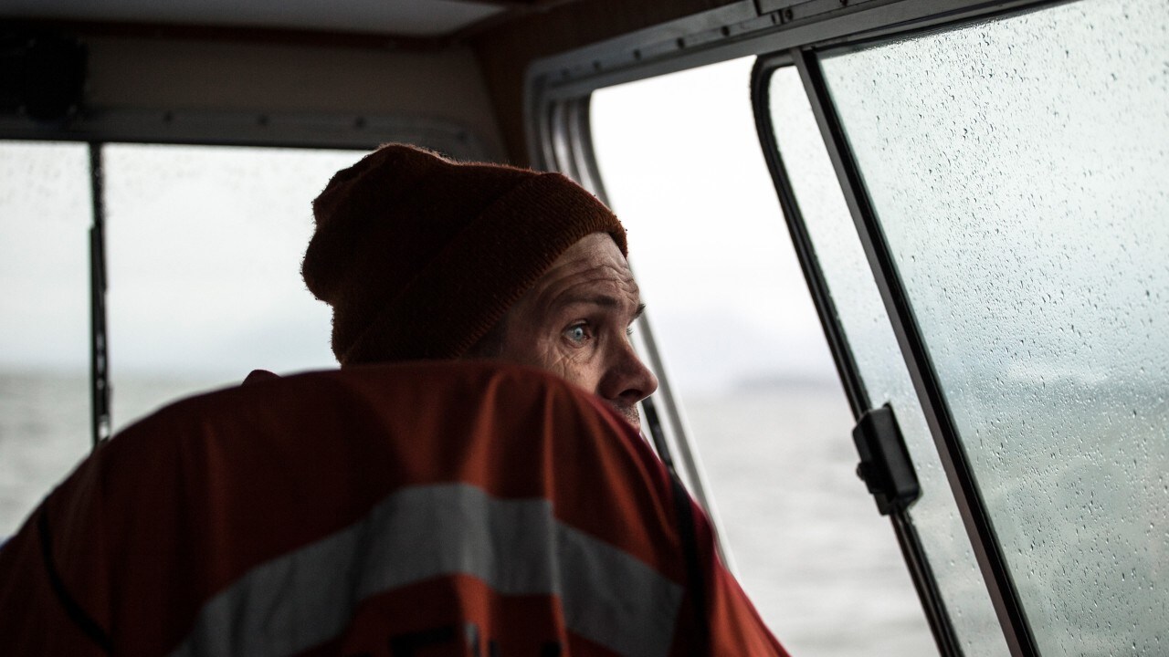 The boat captain takes passengers to the hot springs.