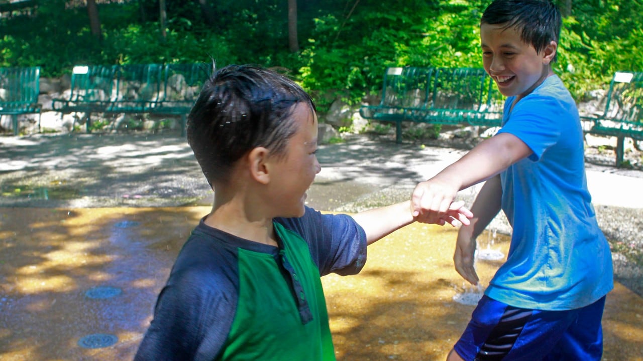 Kids take a break from the animals at the Saint Louis Zoo to enjoy the children's zoo, which offers several play areas with water.