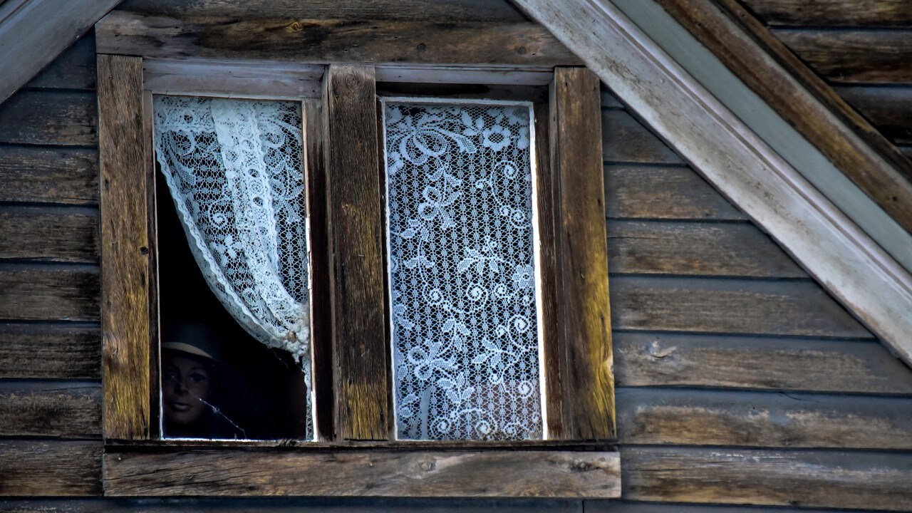 A mannequin peers out a window in St. Elmo.