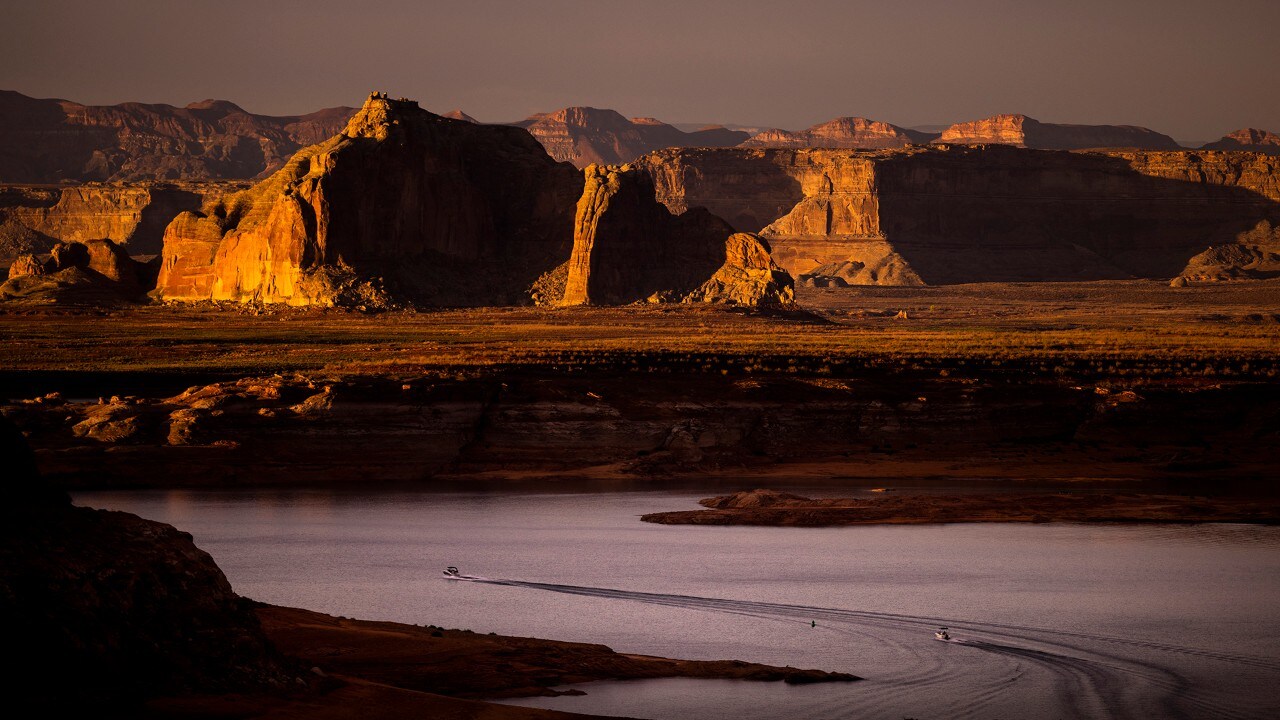 Boats head back toward Wahweap Marina after a day on Lake Powell.