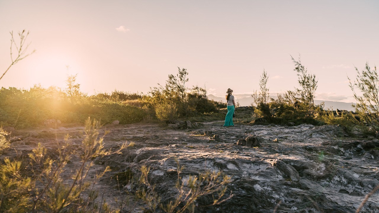 Maria watches the sun set over the ocean at Dragon's Teeth.