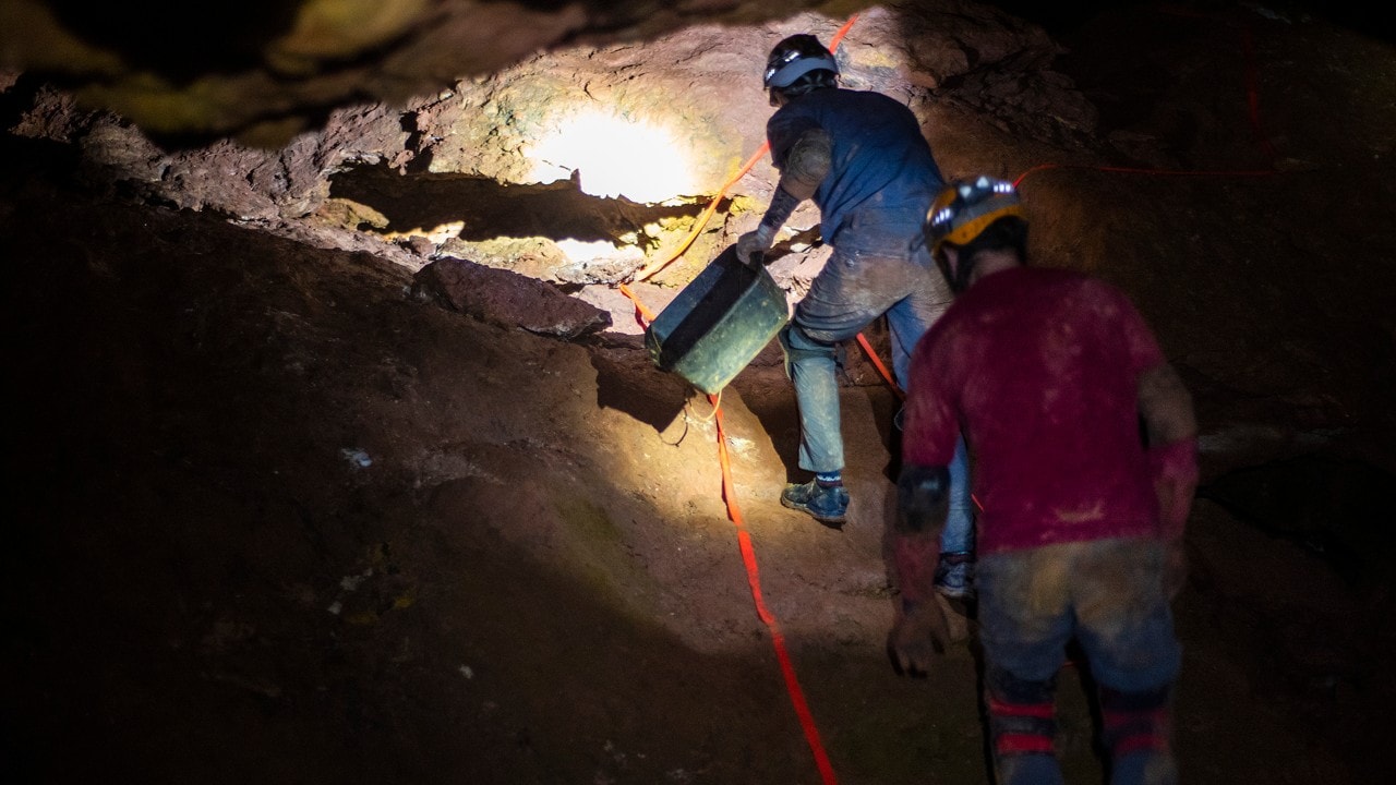 Kaden Franke leads the way to one of Rushmore Cave's active dig sites.