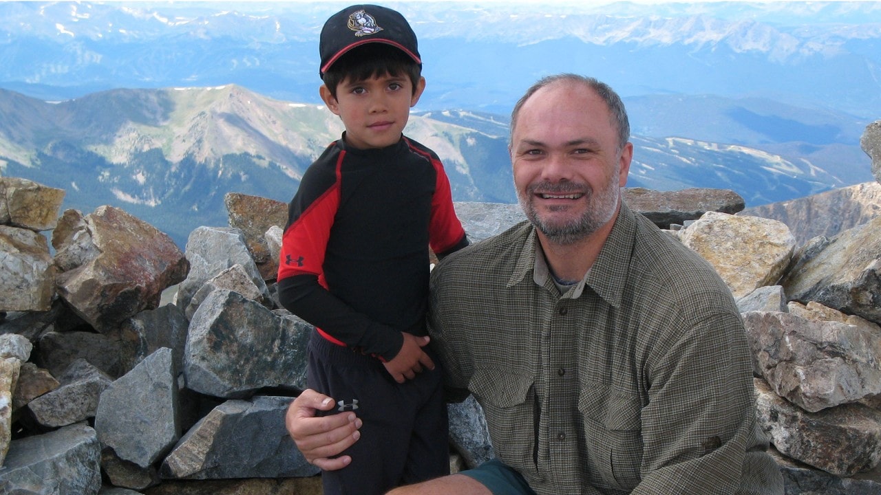 Daniel and Scott Otteman pose at the summit of Mt. Evans, Daniel’s first fourteener. Photo by Shawn Otteman