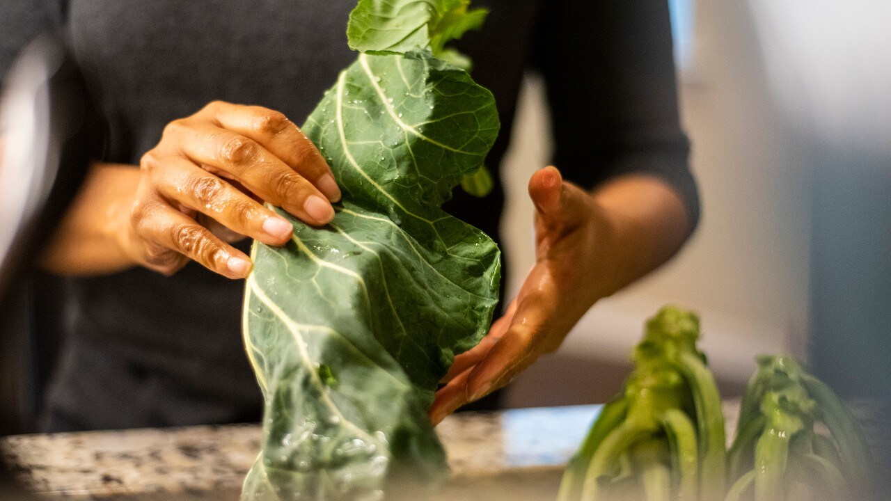 Hailima prepares Brazilian garlic collard greens.