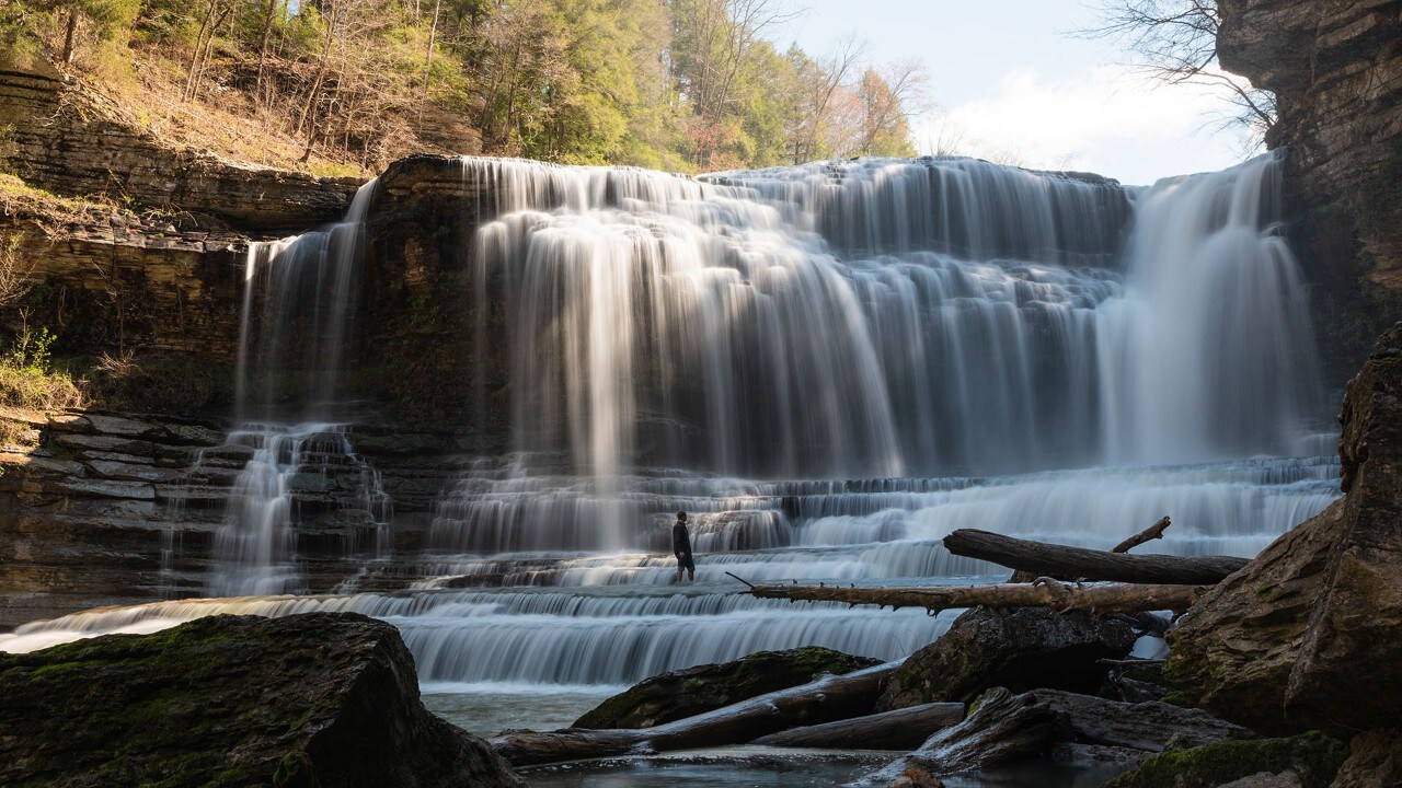 Brennan stands in Cummins Falls, which is 75 feet tall.