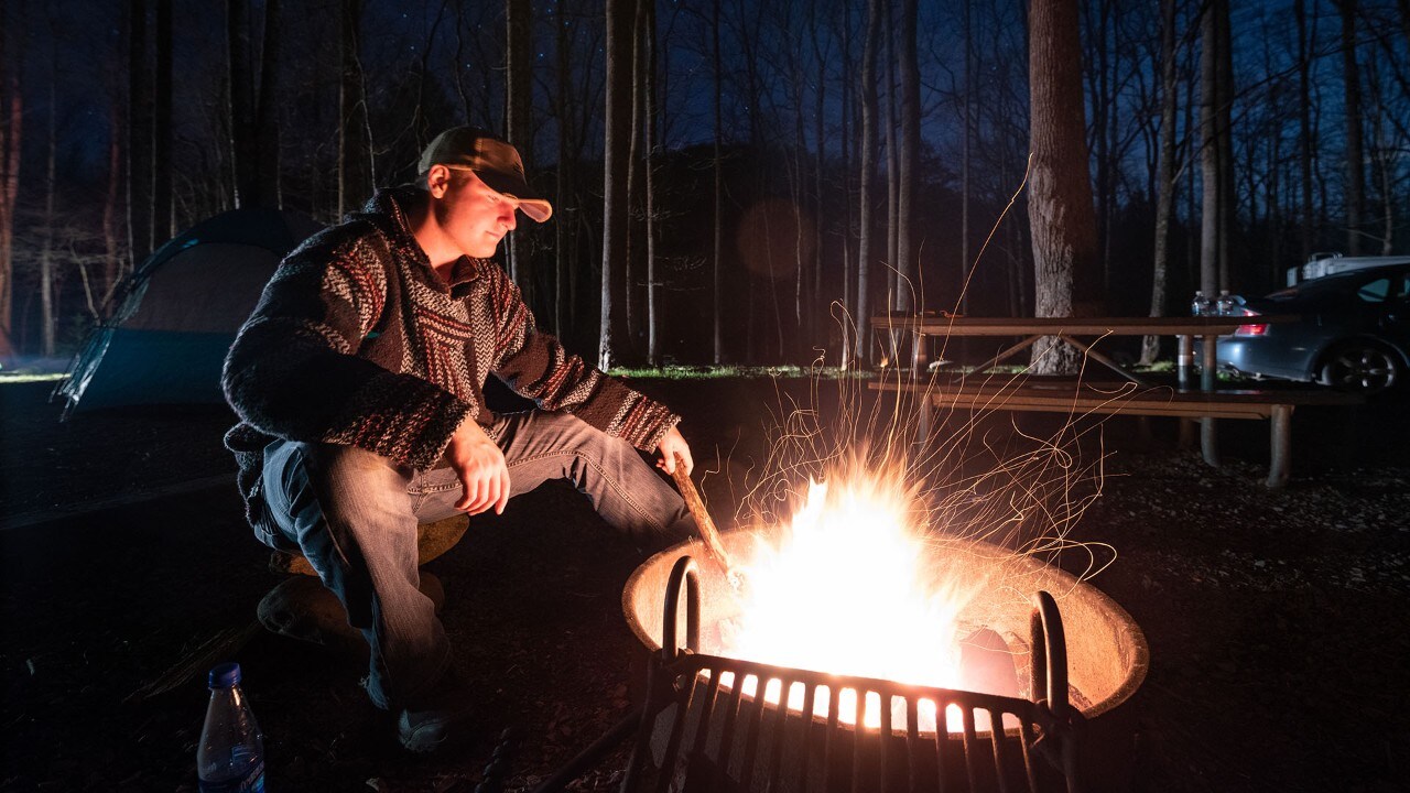 Brennan stirs the fire at Elkmont Campground.