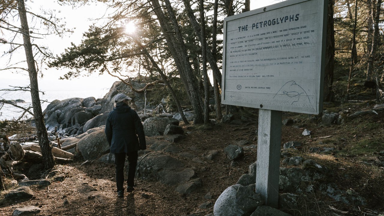 Emma's mom, Mary Jane, visits the petroglyphs in East Sooke Park. 