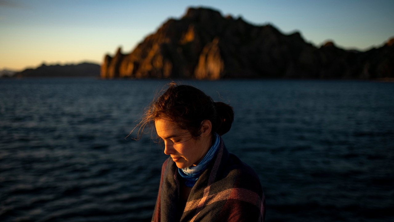 Kassondra soaks up the first rays of sunlight on a catamaran tour around Isla Danzante.