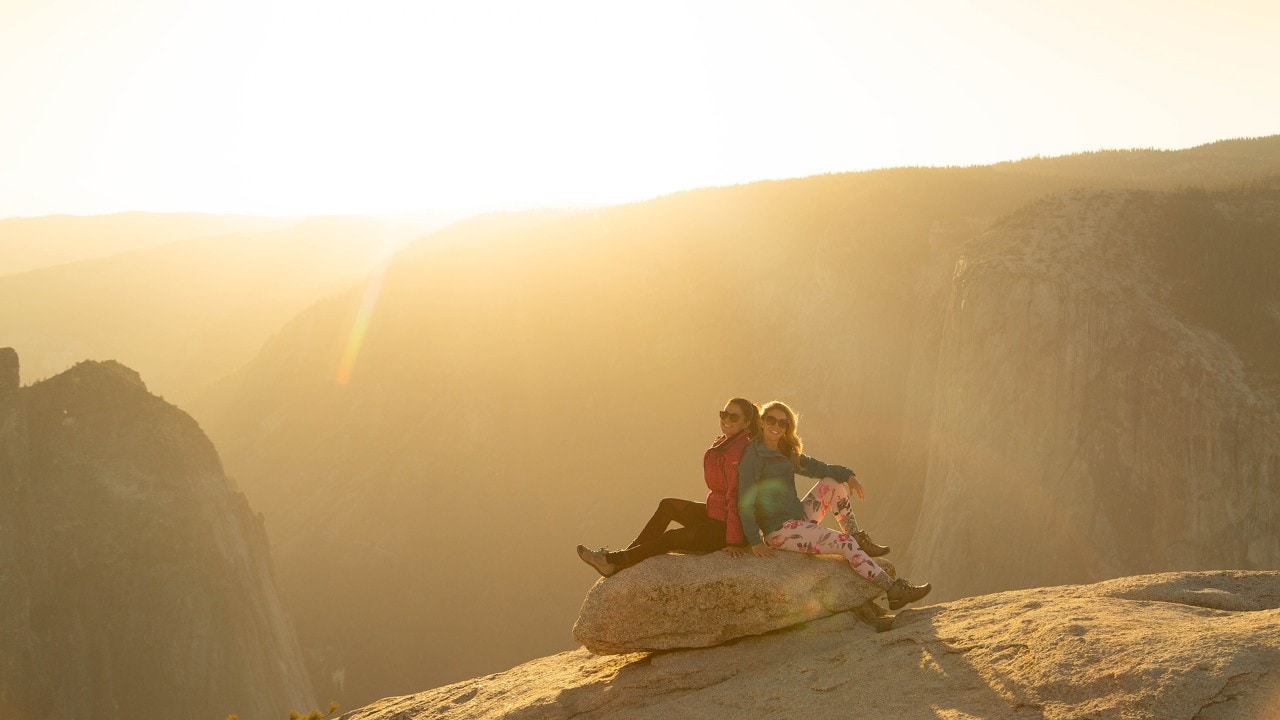 Golden light streams through Taft Point at Yosemite Valley.