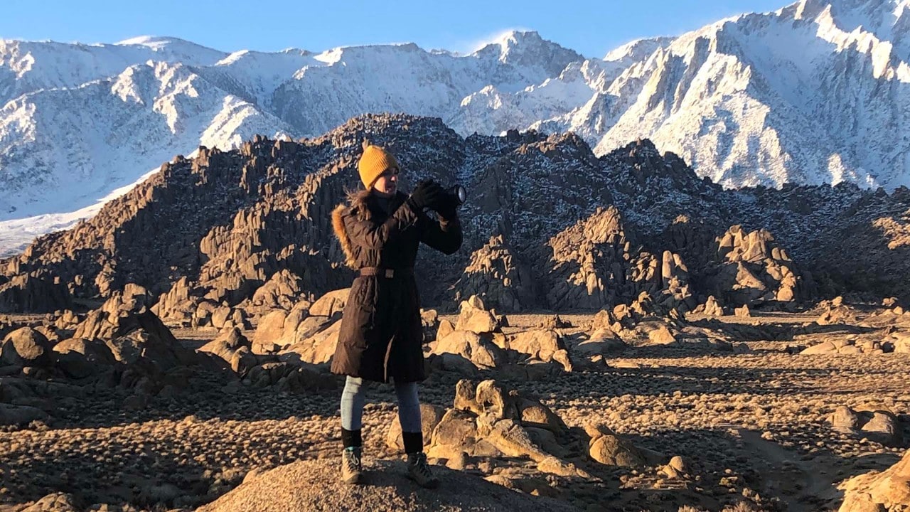 A traveler photographs the pristine mountain views in California's Eastern Sierra. Photo by Megan Snedden