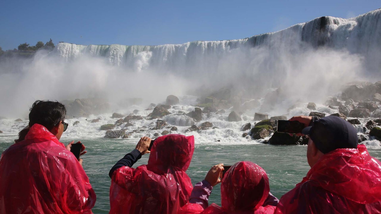 A boat operated by Hornblower Niagara Cruises passes American Falls.