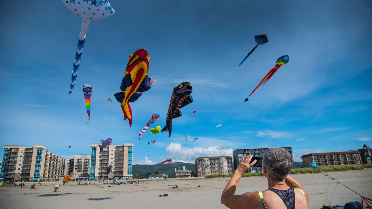 A beachgoer flies kites in Seaside, Oregon. 