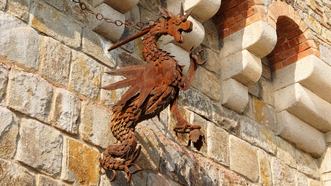 A handcrafted iron dragon guards Castello di Amorosa.