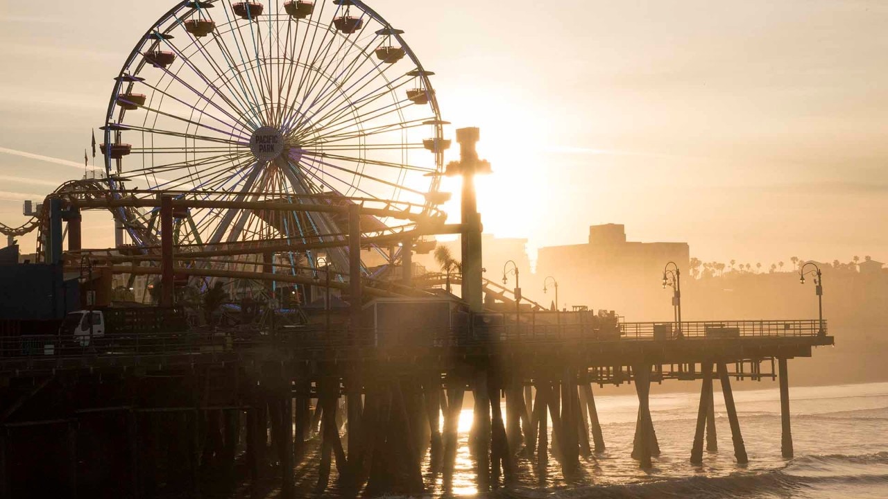 Sunrise illuminates the famous Santa Monica Pier.