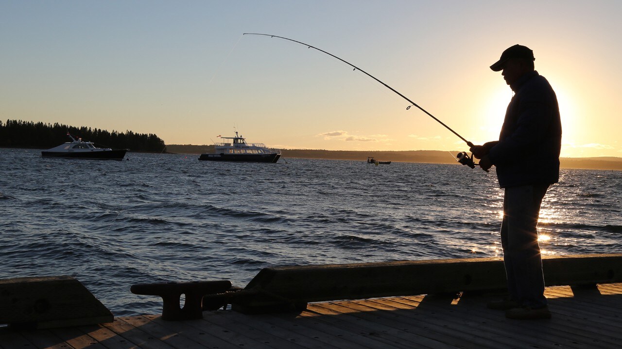 A man fishes from the St. Andrews pier.