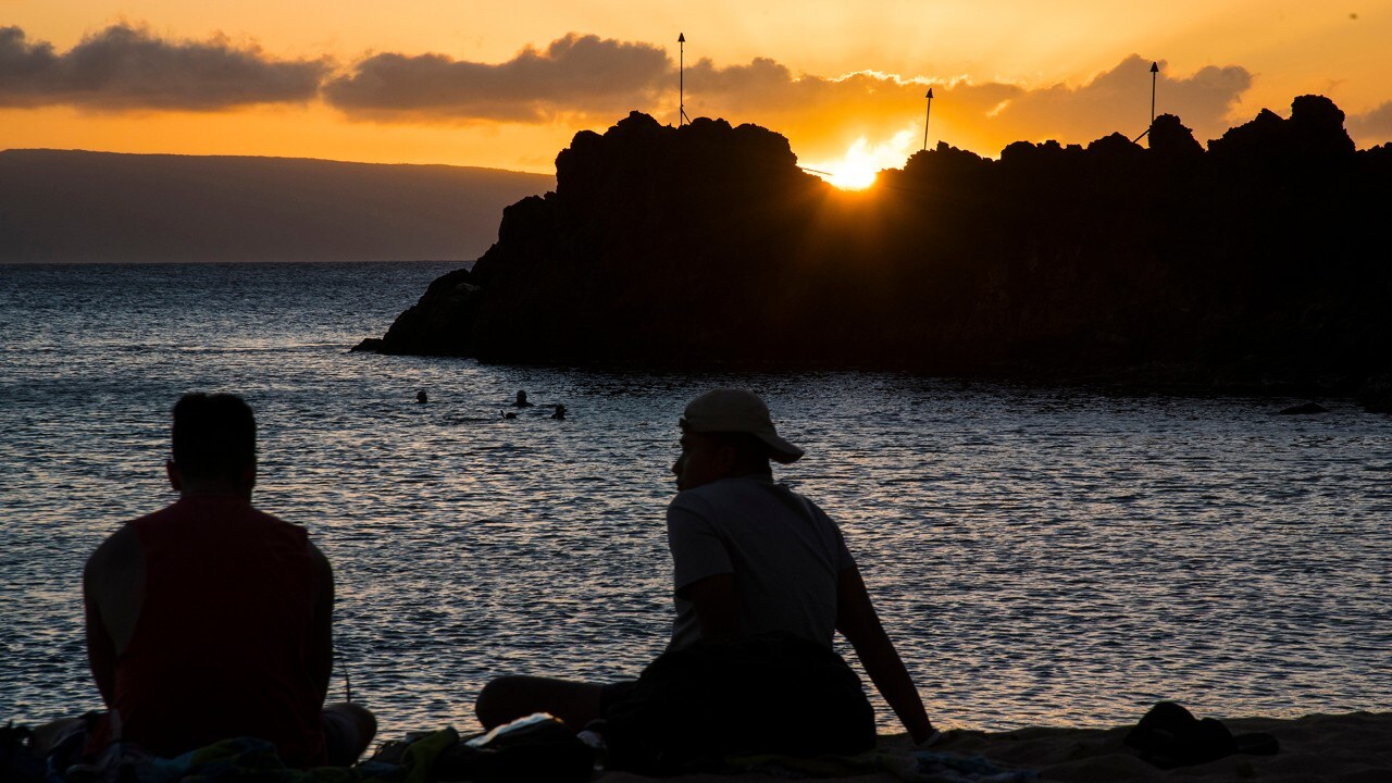 Visitors admire the beautiful sunset at Ka’anapali Beach. 