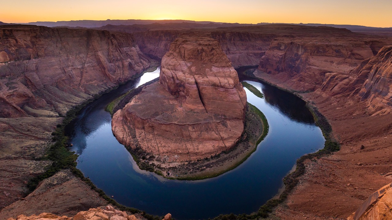 The sun sets behind Horseshoe Bend.