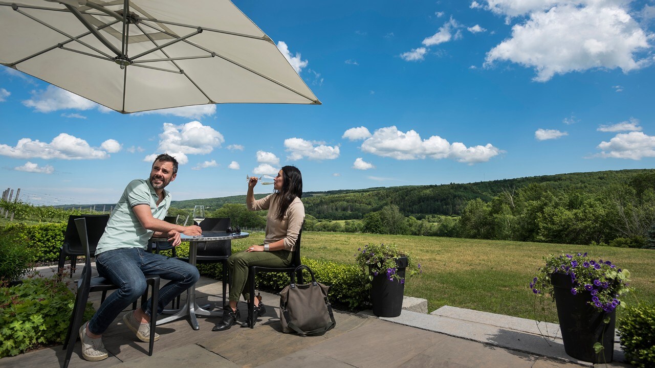 A couple enjoys the wine at Benjamin Bridge.