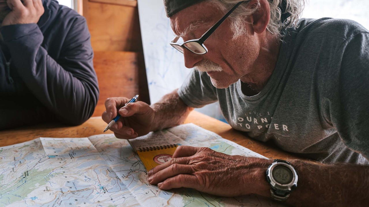 Dave teaches the group how to navigate with paper maps.