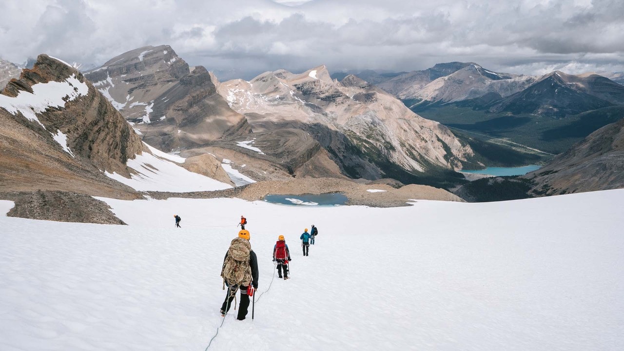 Bow Lake appears in the distance as the group descends.